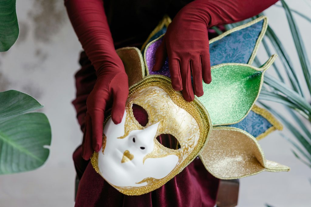 Colorful costume mask with red gloves, embodying the spirit of carnival and celebration.